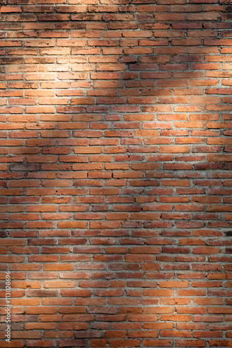 close up view of lights and shadows pattern on red brick wall
