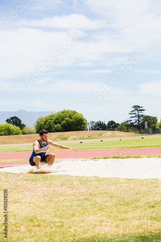 Fotografie Athlete landing on sandpit