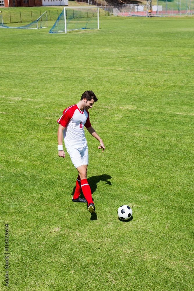 Football player practicing soccer Football player practicing soccer