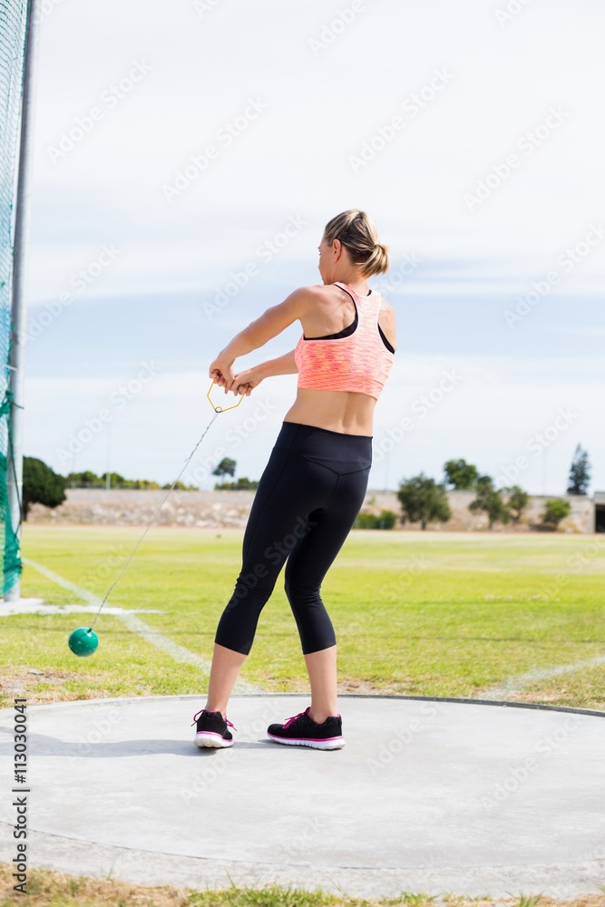 Female athlete performing a hammer throw