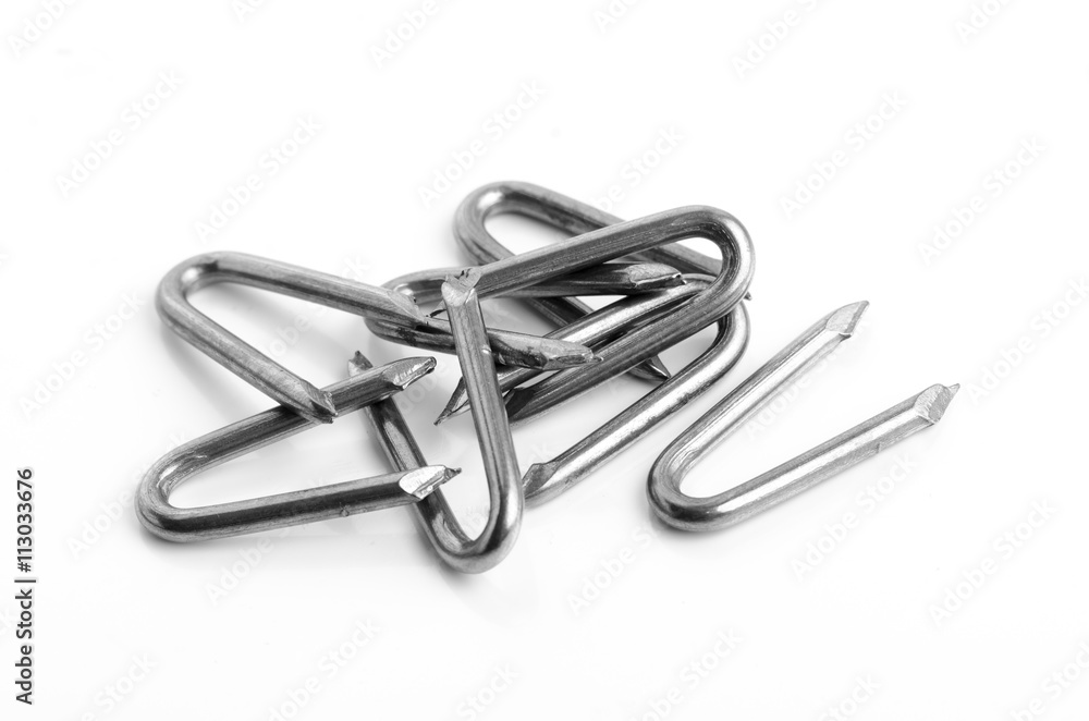 Many metal bent circular nails for wood blending isolated on whi Many metal bent circular nails for wood blending isolated on whi