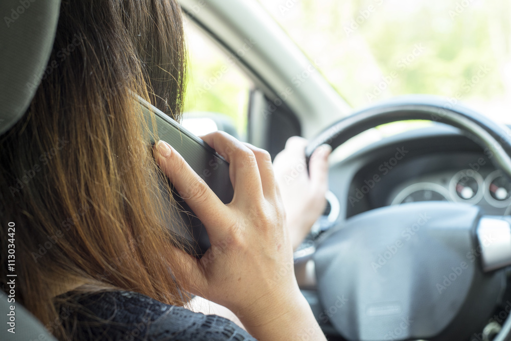 woman with a smartphone in the car