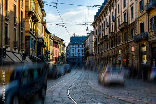Broad Street with tram track among old houses in Milan, Italy. Apply a filter effect motion photo