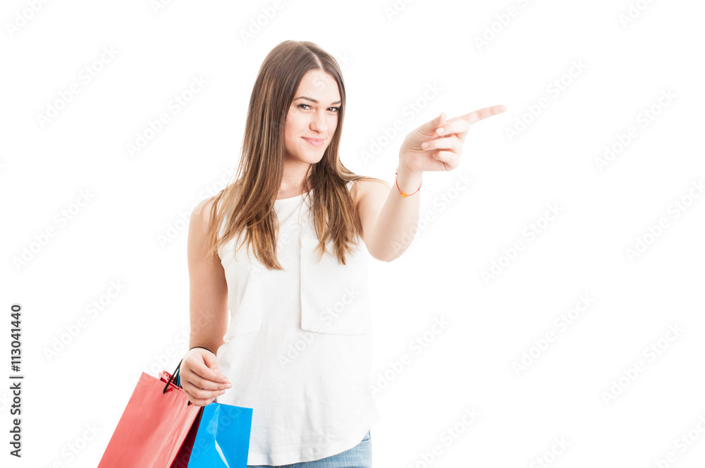 Beautiful young shopaholic indicate left direction with her fing Beautiful young shopaholic indicate left direction with her fing