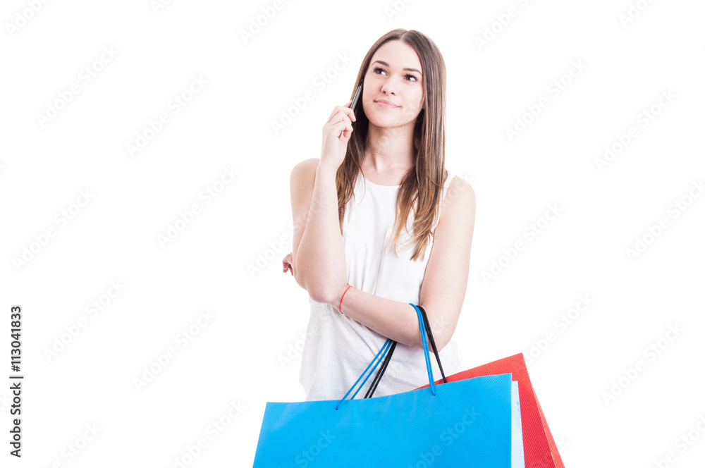 Young woman shopper talking on the phone and looking away Young woman shopper talking on the phone and looking away