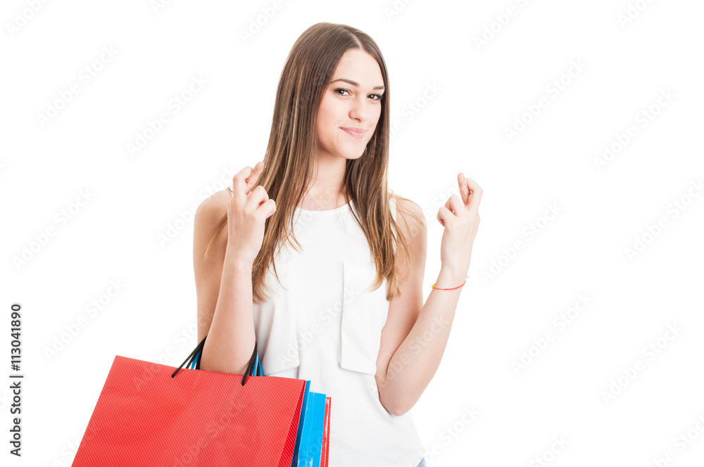 Attractive smiling female at shopping holding finger crossed Attractive smiling female at shopping holding finger crossed