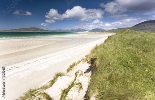 Looking across the machair to the white sand beach of Seilebost at low tide and the hills of Taransay and North Harris, from Seilebost, Isle of Harris, Outer Hebrides, Scotland photo