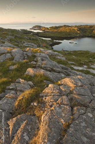 Rocky coasline bathed in early morning light at township of Manish, Isle of Harris, Outer Hebrides, Scotland photo