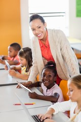 Teacher giving lesson to her students with technology