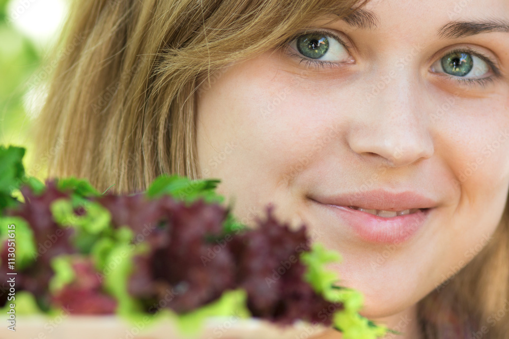 woman holding a plate with fresh greens woman holding a plate with fresh greens