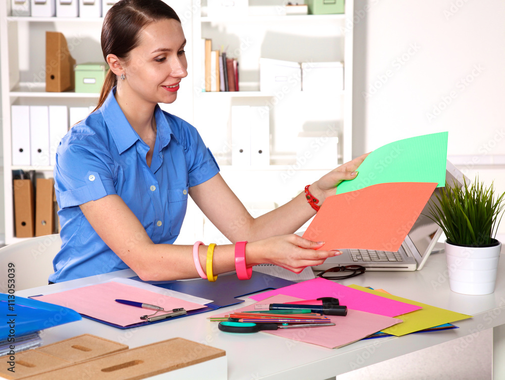 girl Designer in an Office behind a table girl Designer in an Office behind a table