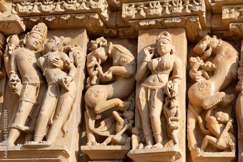Bas-relief with Apsaras at famous ancient temple in Khajuraho, India