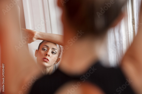Mirror Reflection Of Ballerina Practicing In Studio