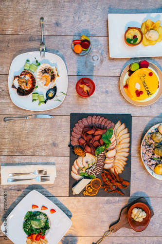 Antipasto catering platter with salami and meat on a wooden background photo