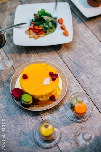 Yellow Cake on wood background. And anothe food. Focus on cake. photo