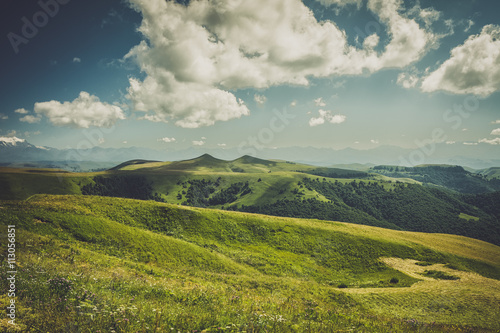 summer mountains landscape green grass and blue sky © Ruslan Grumble
