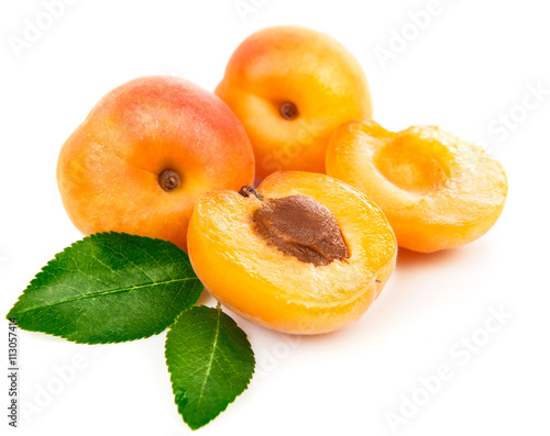 Fresh apricots in section with green leaves