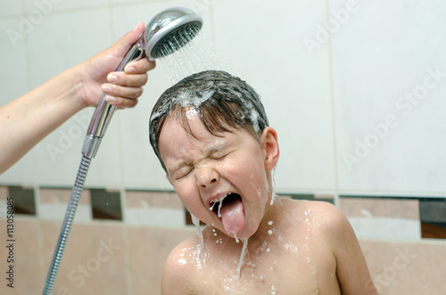 Boy washing hair with shampoo