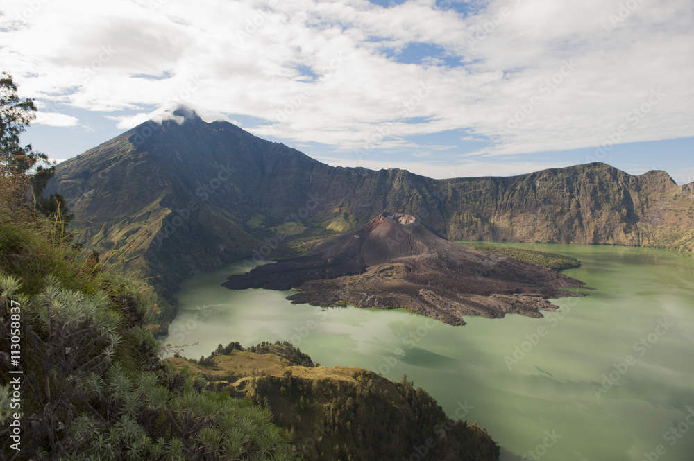 Scenic view of Mount Rinjani against cloudy sky at Lombok, Indonesia Scenic view of Mount Rinjani against cloudy sky at Lombok, Indonesia