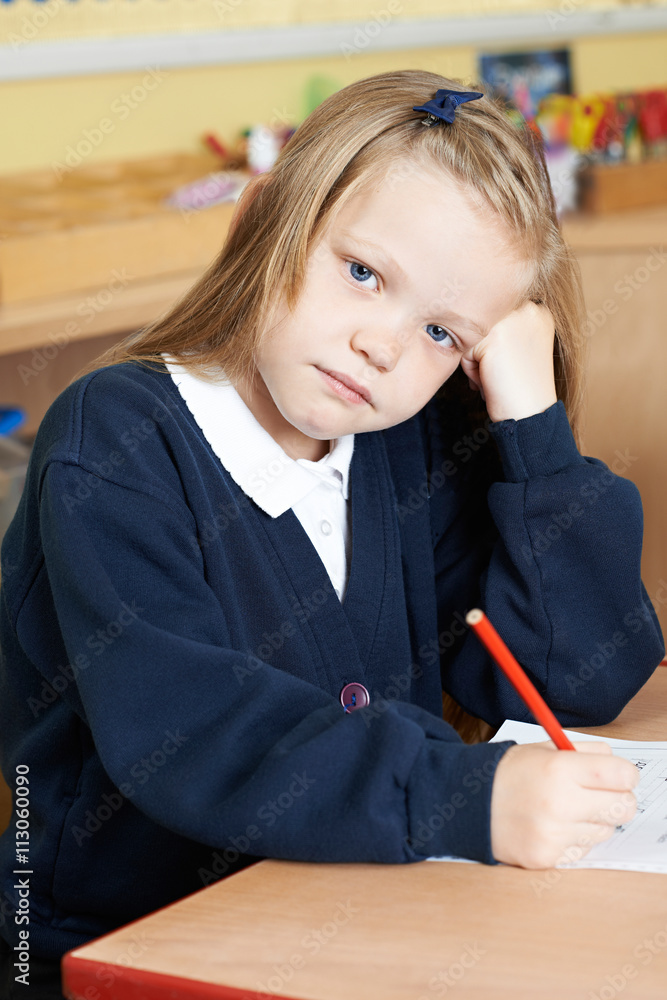 Bored Female Elementary School Pupil At Desk Bored Female Elementary School Pupil At Desk
