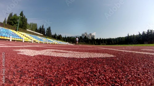 a young man  training in a stadium