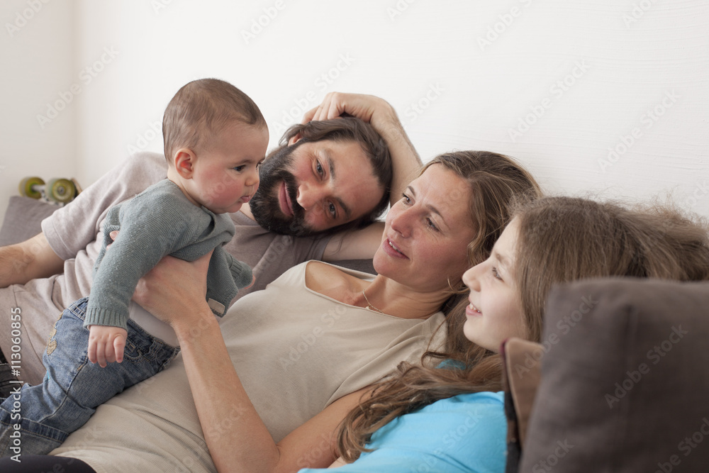 Family looking at baby girl in living room Family looking at baby girl in living room