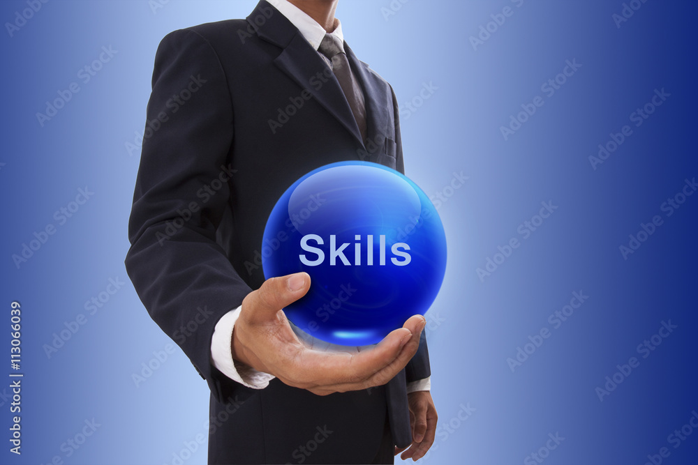 Businessman hand holding blue crystal ball with skills word Businessman hand holding blue crystal ball with skills word