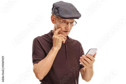 Fotografie Confused senior looking at a cell phone
