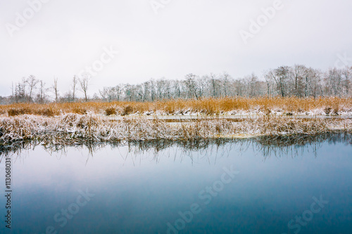 Unfrozen Water Of Lake. Winter Landscape With Snow.