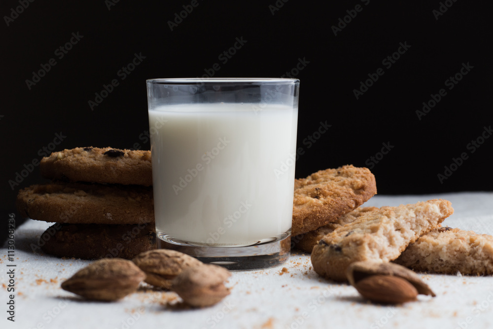 Cookies pile with chocolate chip and almond on light textile background. Delicious morning snacks for breakfast, brunch and lunch. Appetizing, healthy and fast food Cookies pile with chocolate chip and almond on light textile background. Delicious morning snacks for breakfast, brunch and lunch. Appetizing, healthy and fast food