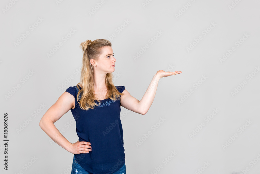 Young woman showing with her hand