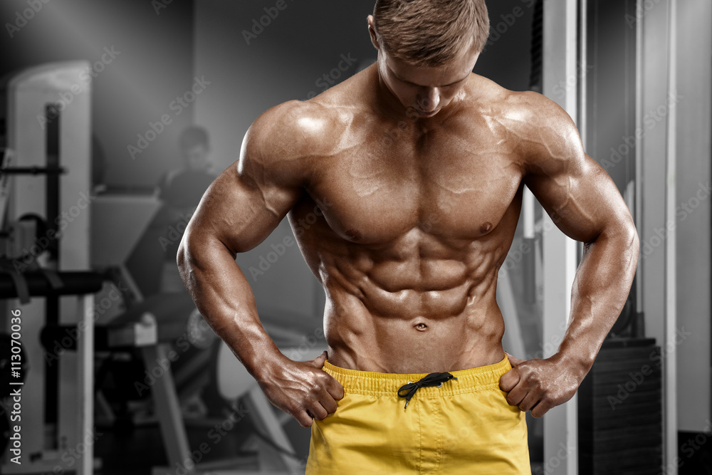 Sexy athletic man showing muscular body and sixpack abs in gym. Strong male  nacked torso, working out Stock Photo | Adobe Stock