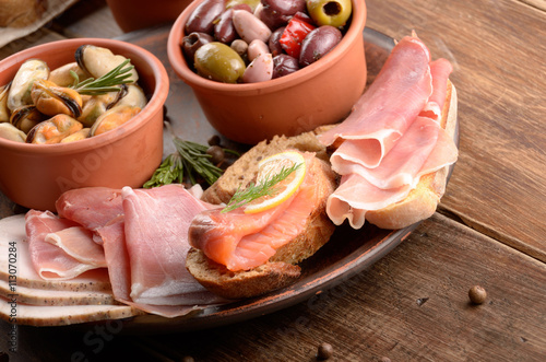 Tapas of salmon, mussels, jamon and olives