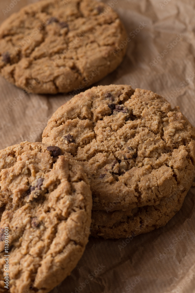 Cookies pile with chocolate chip on light textile background. Delicious morning snacks for breakfast, brunch and lunch. Appetizing, healthy, sweet, scrummy, and fast food. Cookies pile with chocolate chip on light textile background. Delicious morning snacks for breakfast, brunch and lunch. Appetizing, healthy, sweet, scrummy, and fast food.