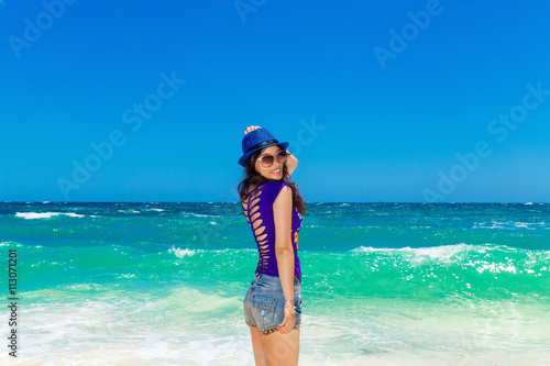 Young beautiful Asian girl on a tropical beach. Summer vacation