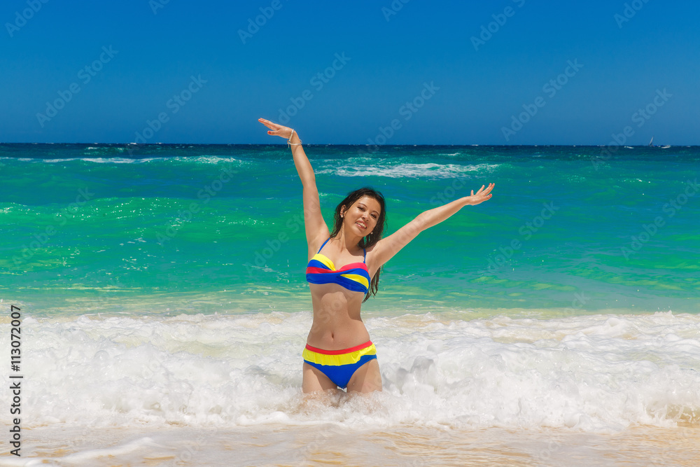 Young beautiful Asian girl with long black hair in bikini, on t Young beautiful Asian girl with long black hair in bikini, on t