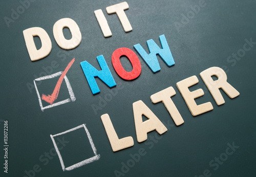Do It Now or Later with checkbox and red check on blackboard