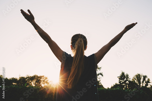 Fotografi Cheering woman open arms at sunrise mountain peak
