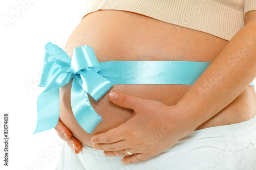 Pregnant woman with blue ribbon over her belly. Hands on tummy. Side view