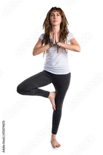 Young girl with dreadlocks doing yoga