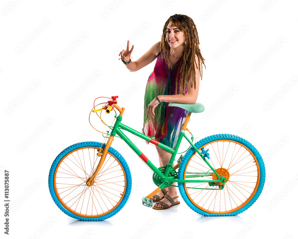 Girl with dreadlocks on colorful bike Girl with dreadlocks on colorful bike