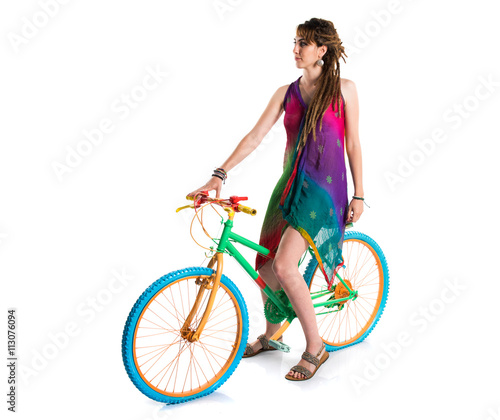 Girl with dreadlocks on colorful bike © luismolinero