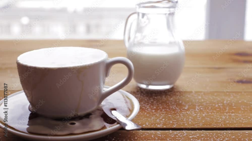 cup full of spilled coffee and sugar on table cup full of spilled coffee and sugar on table
