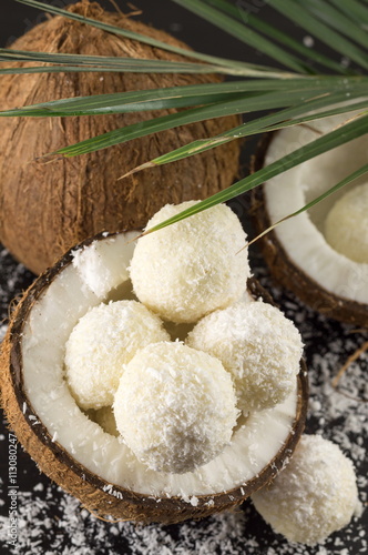 Fresh coconut and coconut cookies on dark background