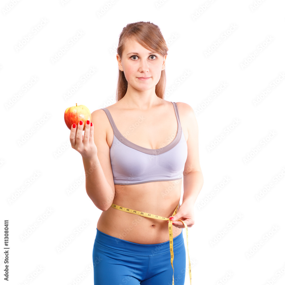 Girl after exercise meter measures your waist on a white background. Girl after exercise meter measures your waist on a white background.
