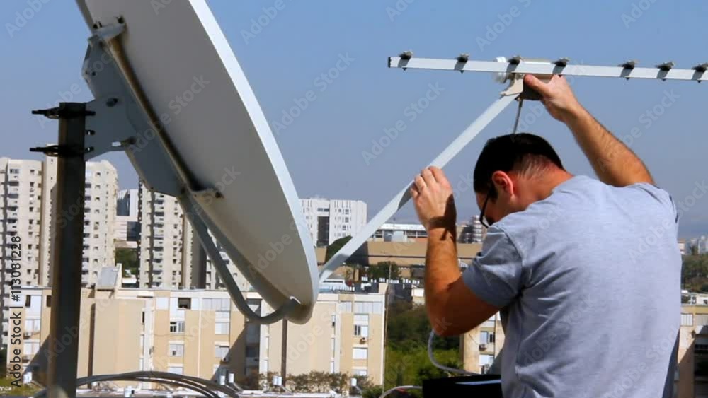 Vidéo Stock Technician installing receiving device of satellite dish in