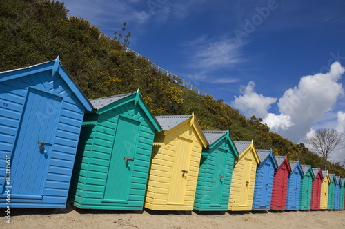 Multicoloured beach huts on the long sweeping beach of Llanbedrog, Llyn Peninsula, Gwynedd, North Wales, Wales photo