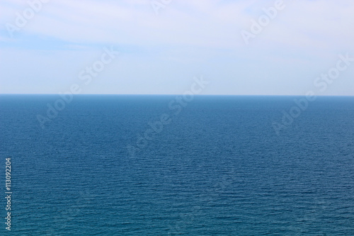 Blue sea waters and clear blue sky horizon