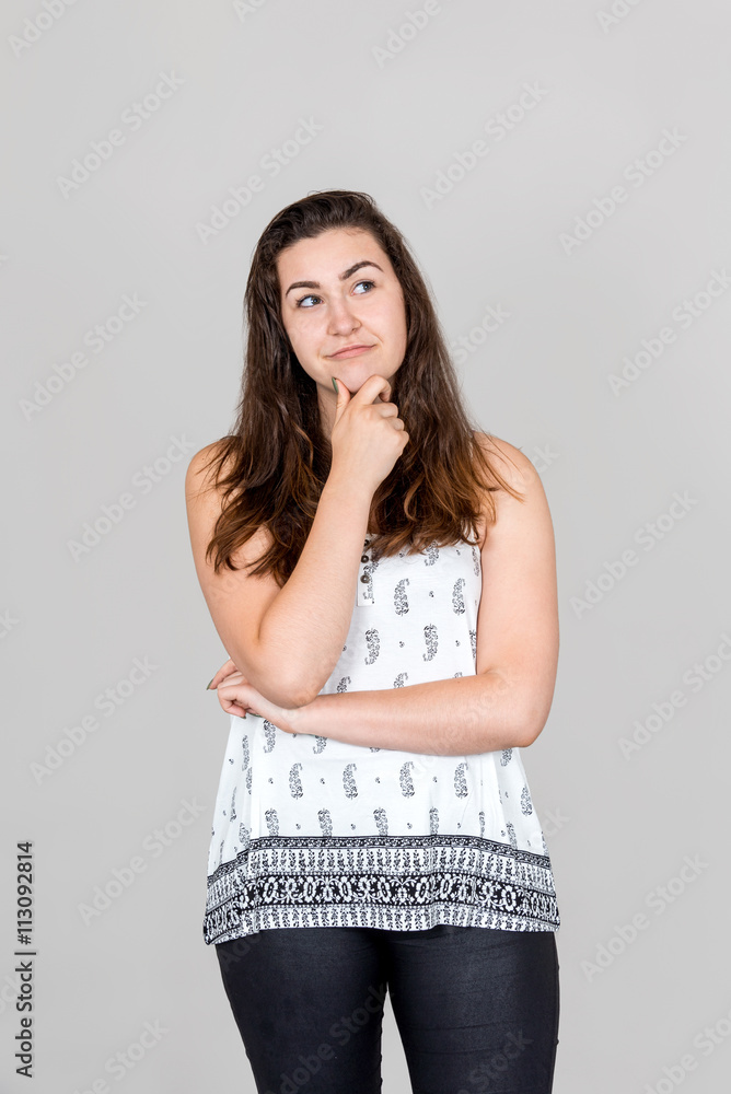 Thoughtful woman with hand on chin Thoughtful woman with hand on chin