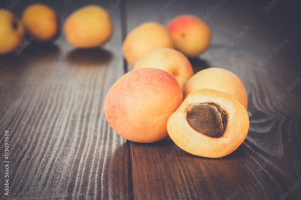 some fresh apricots over brown wooden background